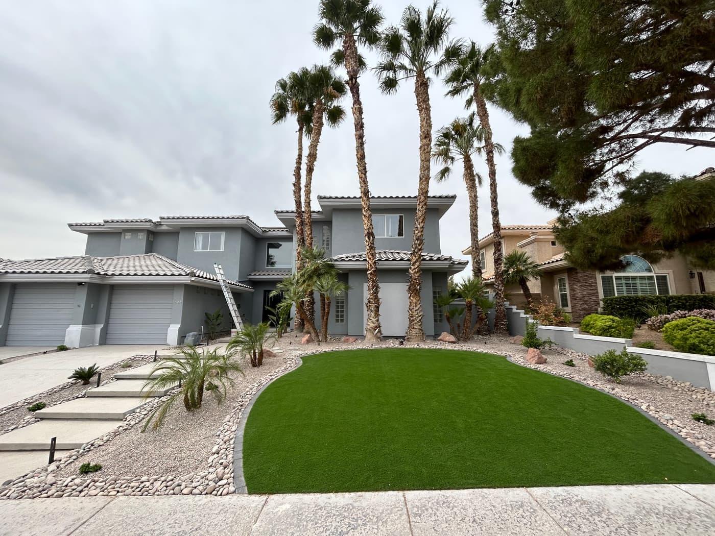 Custom concrete driveway, steps, and curved turf design in a Las Vegas front yard